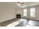 Bright living room features a fireplace, large windows, and wood-look flooring at 1749 Daiquiri Turn, Sanford, NC 27332