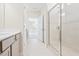 Modern bathroom featuring a glass shower, neutral tones, and tile floors with a view to another room at 1991 Meadowview Dr, Graham, NC 27253