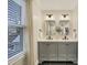Bathroom featuring a double vanity with neutral cabinets and a view to the neighborhood at 206 Steep Bank Dr, Cary, NC 27518