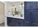 Bathroom featuring a double vanity with stylish blue cabinets and brushed metal fixtures at 206 Steep Bank Dr, Cary, NC 27518