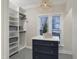 A closet with white shelving surrounds a marble top island with plenty of storage at 206 Steep Bank Dr, Cary, NC 27518