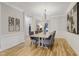 Bright dining room with wainscoting, chandelier, and open access to other living spaces at 206 Steep Bank Dr, Cary, NC 27518