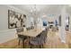 Formal dining room with modern chandelier, long wooden table, and views into the living room at 206 Steep Bank Dr, Cary, NC 27518