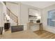 Dining space adjacent to the staircase with wood floors, modern lighting, and wall art at 206 Steep Bank Dr, Cary, NC 27518