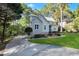 Landscaped home exterior featuring a long driveway and stone and siding accents at 206 Steep Bank Dr, Cary, NC 27518