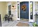 Inviting entryway with a decorative fall wreath on the dark, stately front door at 206 Steep Bank Dr, Cary, NC 27518