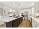 Well-lit kitchen featuring a large island with cooktop and stainless steel appliances at 206 Steep Bank Dr, Cary, NC 27518