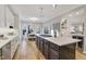 Bright kitchen with stainless steel appliances, a central island with cooktop, and an adjacent dining area at 206 Steep Bank Dr, Cary, NC 27518