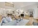 Open-concept living room with high ceilings, comfortable seating, and access to other living spaces at 206 Steep Bank Dr, Cary, NC 27518