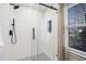 Modern shower with black hardware, white subway tile, and decorative patterned floor at 206 Steep Bank Dr, Cary, NC 27518