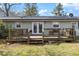 Home exterior showcasing a spacious wooden deck, ideal for relaxing and entertaining outdoors at 245 Cedar Crk Rd, Franklinton, NC 27525