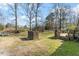 Expansive backyard featuring mature trees and a bricked space, ideal for outdoor enjoyment at 245 Cedar Crk Rd, Franklinton, NC 27525