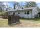 Home exterior and backyard with a spacious deck and lawn, perfect for outdoor enjoyment at 245 Cedar Crk Rd, Franklinton, NC 27525