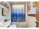 This bathroom features a toilet and a shower with a blue and white curtain at 245 Cedar Crk Rd, Franklinton, NC 27525