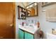 This bathroom features a sink, a mirror, and a wooden door at 245 Cedar Crk Rd, Franklinton, NC 27525