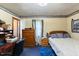 This bedroom features a twin bed, dresser, desk, and blue carpet at 245 Cedar Crk Rd, Franklinton, NC 27525