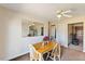 Simple dining area with a wooden table, chairs, and a wall mirror reflecting the room's layout at 245 Cedar Crk Rd, Franklinton, NC 27525