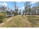Single-story home with a long front porch, set amidst mature trees and a spacious front yard at 245 Cedar Crk Rd, Franklinton, NC 27525