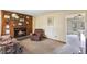 Cozy living room featuring a wood-paneled wall with fireplace and comfortable seating at 245 Cedar Crk Rd, Franklinton, NC 27525