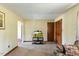 Spacious living room with neutral carpeting, light-colored walls, and a view into another room at 245 Cedar Crk Rd, Franklinton, NC 27525