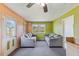 Simple living room featuring neutral sofas, an exterior door, and adequate natural light at 245 Cedar Crk Rd, Franklinton, NC 27525