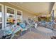 Inviting covered back porch with outdoor seating and a view of the backyard at 2490 Earpsboro Rd, Zebulon, NC 27597
