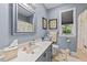 Well-lit bathroom featuring a white vanity, a large mirror, and a window for natural light at 2490 Earpsboro Rd, Zebulon, NC 27597