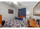 Comfortable bedroom with a queen-size bed, a bedside table, and a desk at 2490 Earpsboro Rd, Zebulon, NC 27597