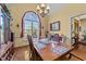 Inviting dining room with a grand window, stylish chandelier, and beautifully set table for meals at 2490 Earpsboro Rd, Zebulon, NC 27597