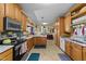 Charming kitchen with wooden cabinets, a modern oven, and a view into the dining area at 2490 Earpsboro Rd, Zebulon, NC 27597