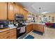 Well-lit kitchen with stainless steel appliances, marble countertops, and a view into the dining area at 2490 Earpsboro Rd, Zebulon, NC 27597