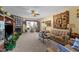 Spacious living room with a stone fireplace, comfortable seating, and lots of natural light at 2490 Earpsboro Rd, Zebulon, NC 27597