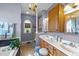 Main bathroom offers a double vanity, beautiful chandelier, and a large soaking tub at 2490 Earpsboro Rd, Zebulon, NC 27597
