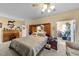 Spacious main bedroom with a desk, a bed with headboard storage, and a view to the sun room at 2490 Earpsboro Rd, Zebulon, NC 27597
