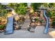 A playground features slides and stone stairs through the grassy landscape at 2806 Kempthorne Rd # 62, Cary, NC 27519