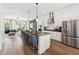 Open-concept kitchen featuring stainless steel appliances, a kitchen island, and stylish pendant lighting at 2812 Kempthorne Rd # 59, Cary, NC 27519