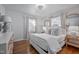 Bright, all-white bedroom with hardwood floors and detailed furniture at 2836 Oberlin Rd, Raleigh, NC 27608