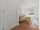 Cozy bedroom featuring neutral decor, a comfortable bed, and a charming rattan side table with a lamp at 2836 Oberlin Rd, Raleigh, NC 27608