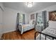 Shared bedroom with hardwood floors, bright windows, and natural light at 2836 Oberlin Rd, Raleigh, NC 27608