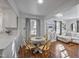 Charming dining area with a round table, wicker chairs, and ample natural light at 2836 Oberlin Rd, Raleigh, NC 27608