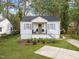 Charming single-story home with white siding, dark roof, green front lawn and a welcoming front porch at 2836 Oberlin Rd, Raleigh, NC 27608