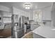Bright, white kitchen featuring stainless steel appliances, quartz countertops, and modern fixtures at 2836 Oberlin Rd, Raleigh, NC 27608