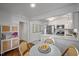 Bright dining area with seating that overlooks the modern kitchen with stainless appliances and white cabinets at 2836 Oberlin Rd, Raleigh, NC 27608