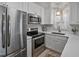 Bright kitchen featuring stainless steel appliances, white cabinetry, and quartz countertops at 2836 Oberlin Rd, Raleigh, NC 27608