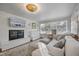 Inviting living room boasts a brick fireplace, large windows, a comfy sofa, and an decorative ceiling light at 2836 Oberlin Rd, Raleigh, NC 27608
