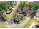 An aerial view of a residential area with well-maintained houses, lush greenery, and paved roads at 2867, 2851 Nc-210 & Galilee Hwy, Smithfield, NC 27577