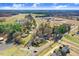 Scenic aerial view showcasing the property's proximity to a pond, trees, local roadways, and community features at 2867, 2851 Nc-210 & Galilee Hwy, Smithfield, NC 27577