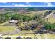Wide aerial shot of the property featuring expansive treed areas, lawns, and nearby roads at 2867, 2851 Nc-210 & Galilee Hwy, Smithfield, NC 27577