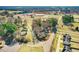 Comprehensive aerial view of the property with trees, pond, nearby buildings, and community layout at 2867, 2851 Nc-210 & Galilee Hwy, Smithfield, NC 27577