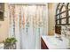 Bathroom showcasing a colorful floral shower curtain and an updated sink and faucet at 2867, 2851 Nc-210 & Galilee Hwy, Smithfield, NC 27577